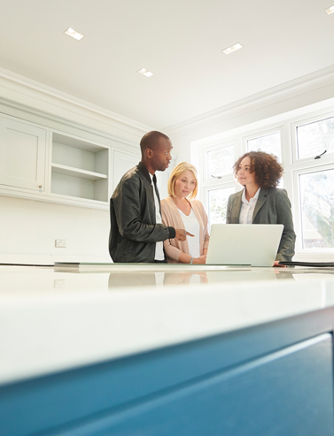 couple having a discusson with their real estate agent in front of a computer